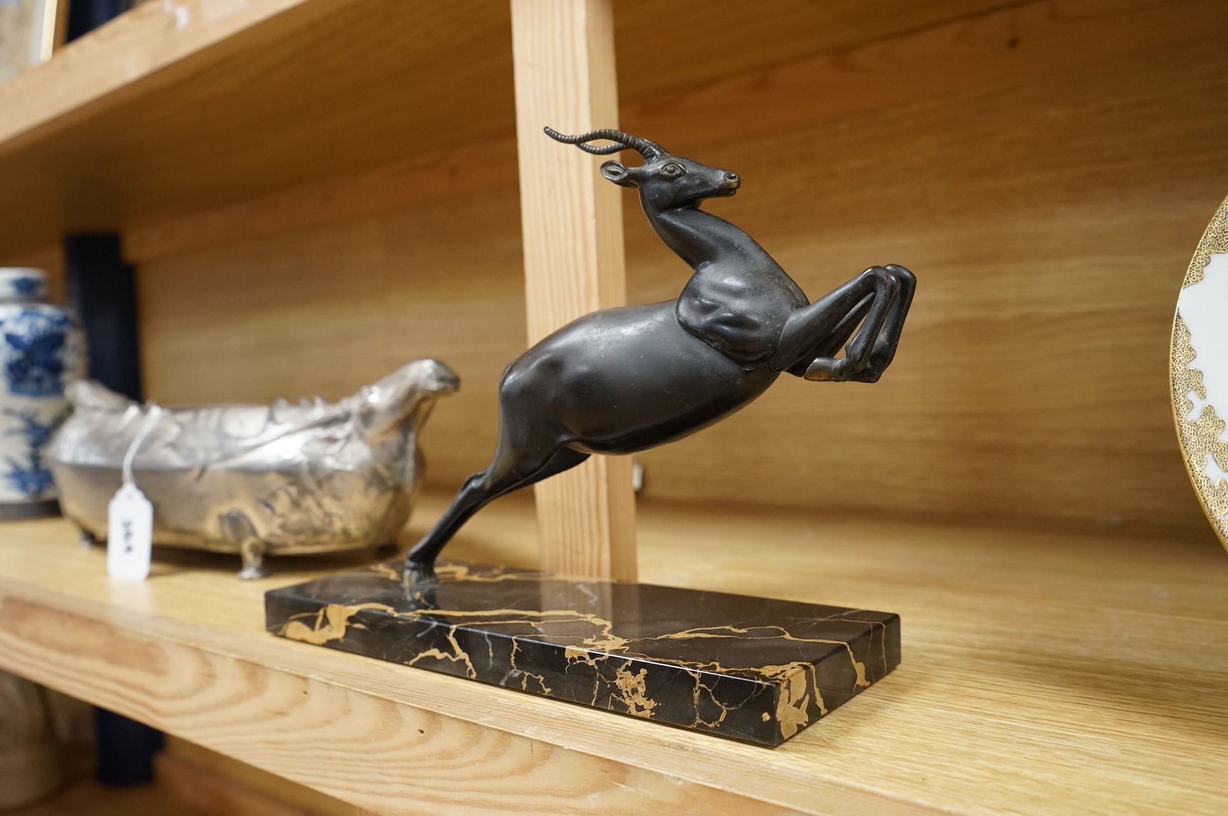 An Art Deco spelter study of a leaping gazelle, 27cm wide